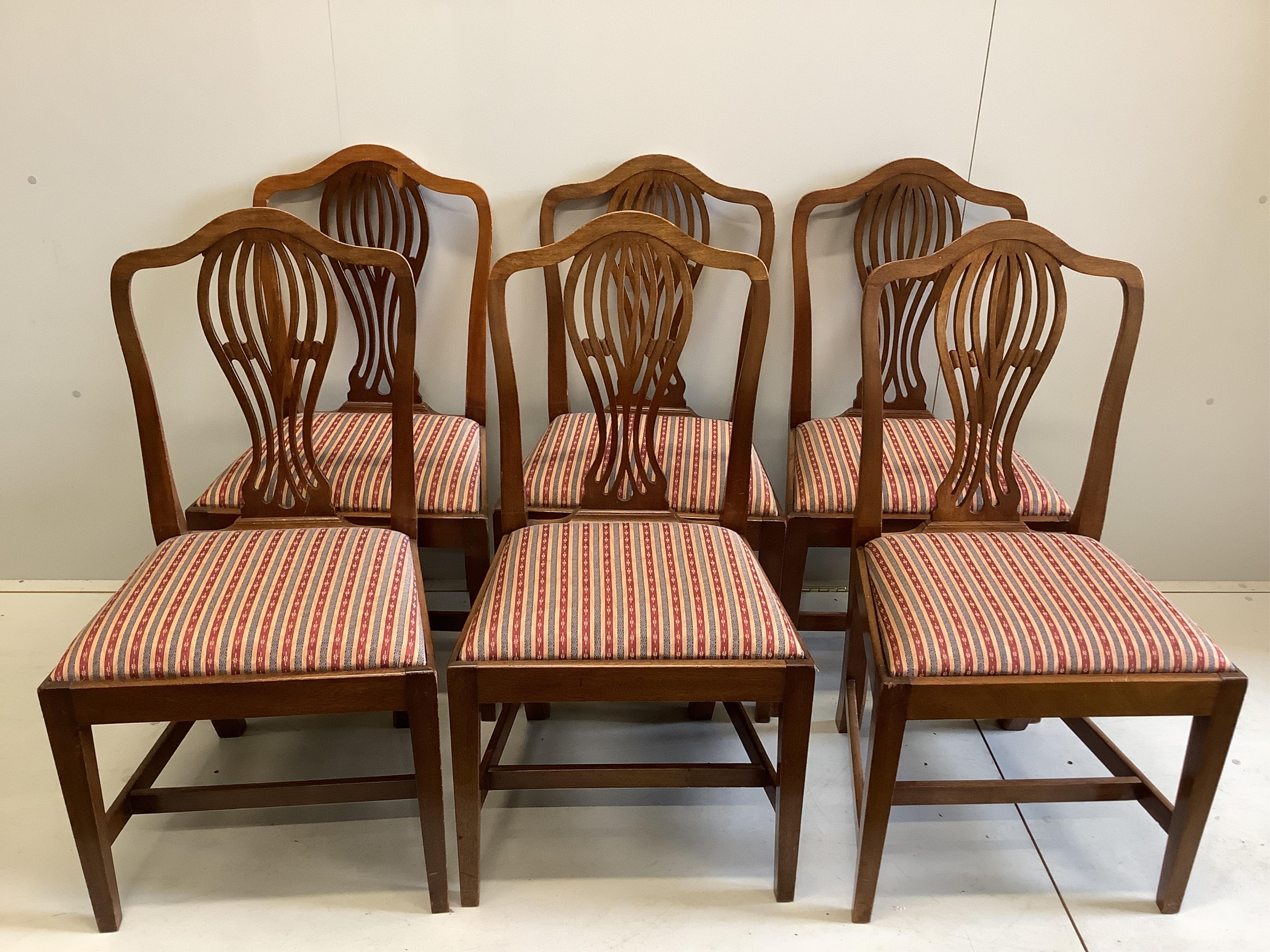 A George III style oval mahogany drop leaf dining table, 155cm extended, depth 106cm, height 74cm, together with a Regency style mahogany bowfront sideboard and six Hepplewhite style mahogany dining chairs. Condition - f